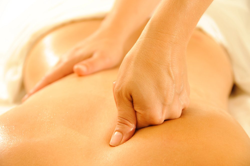 Therapist performing back massage with professional technique
