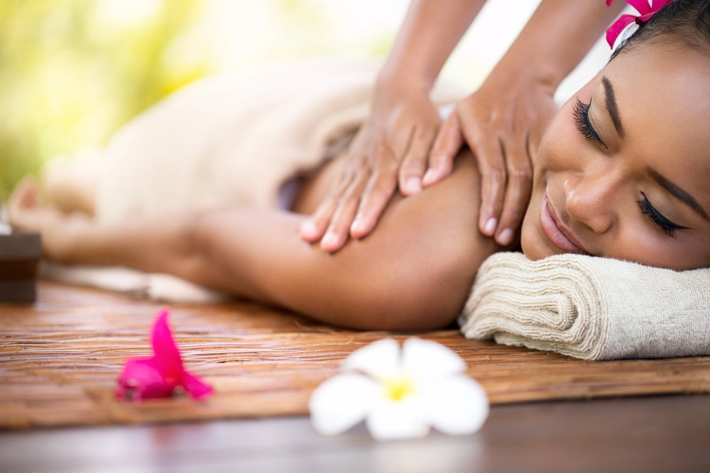 Hot stone massage therapy on back muscles