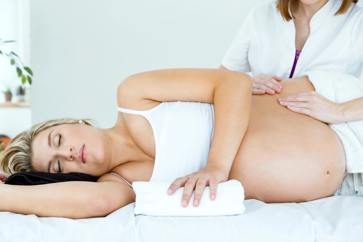 Pregnant woman receiving therapeutic prenatal massage